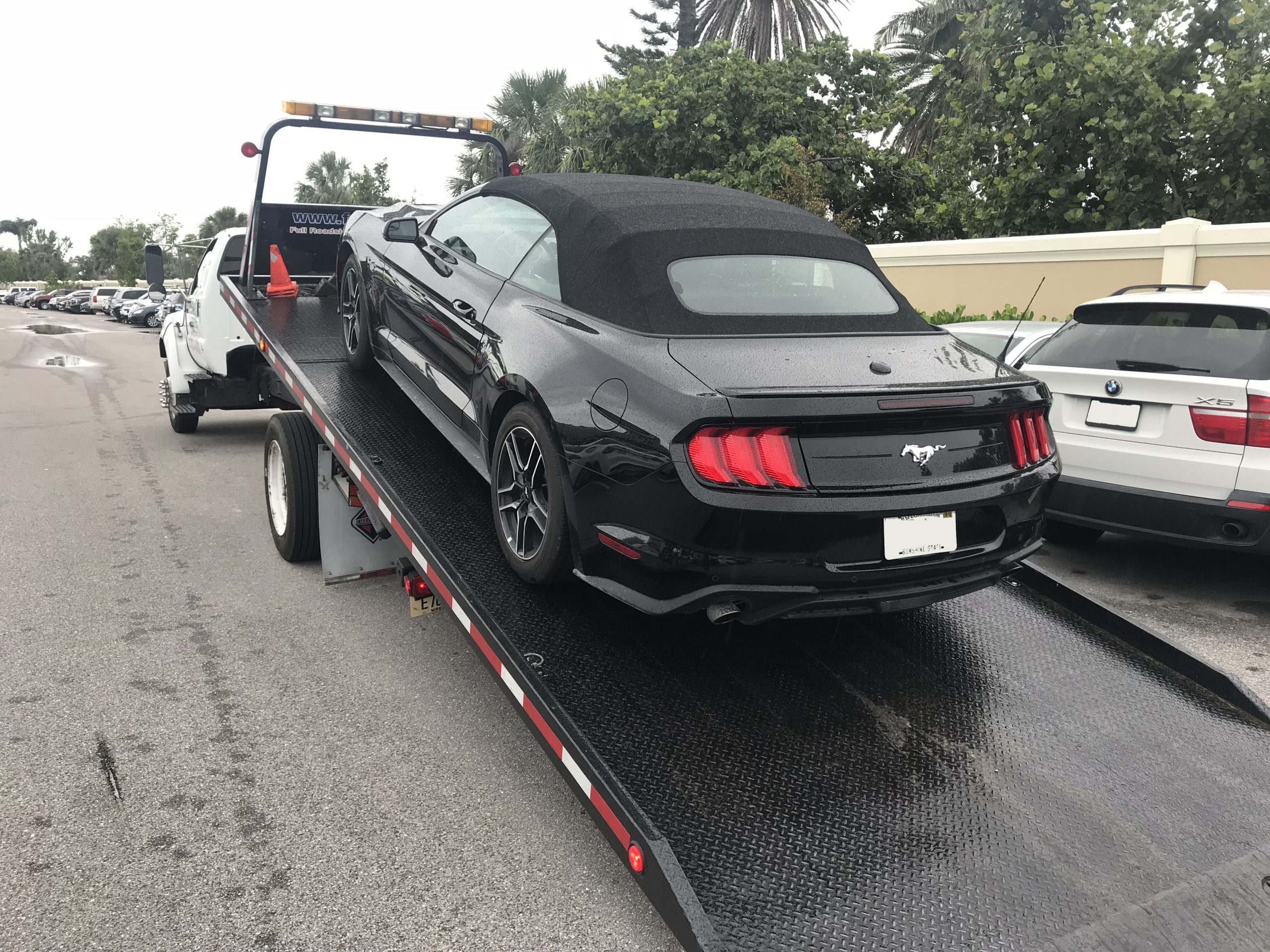 Black Mustang on Fraga towing flatbed